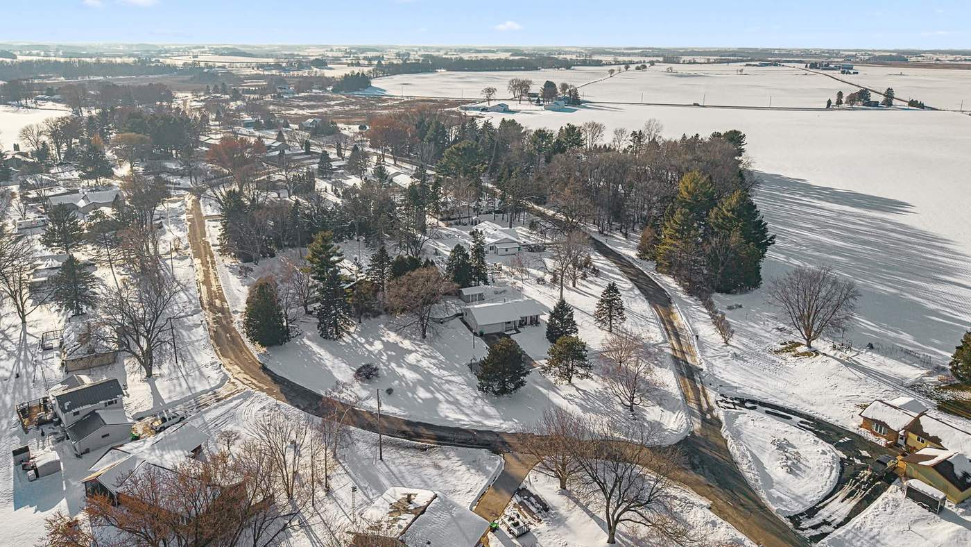 Aerial view of a Beaver Dam neighborhood beside a frozen Beaver Dam Lake in winter.